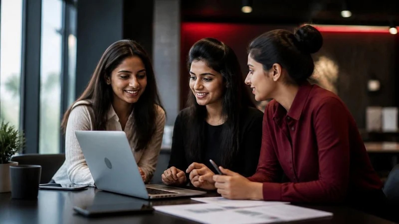Young professionals planning a digital project together on a laptop